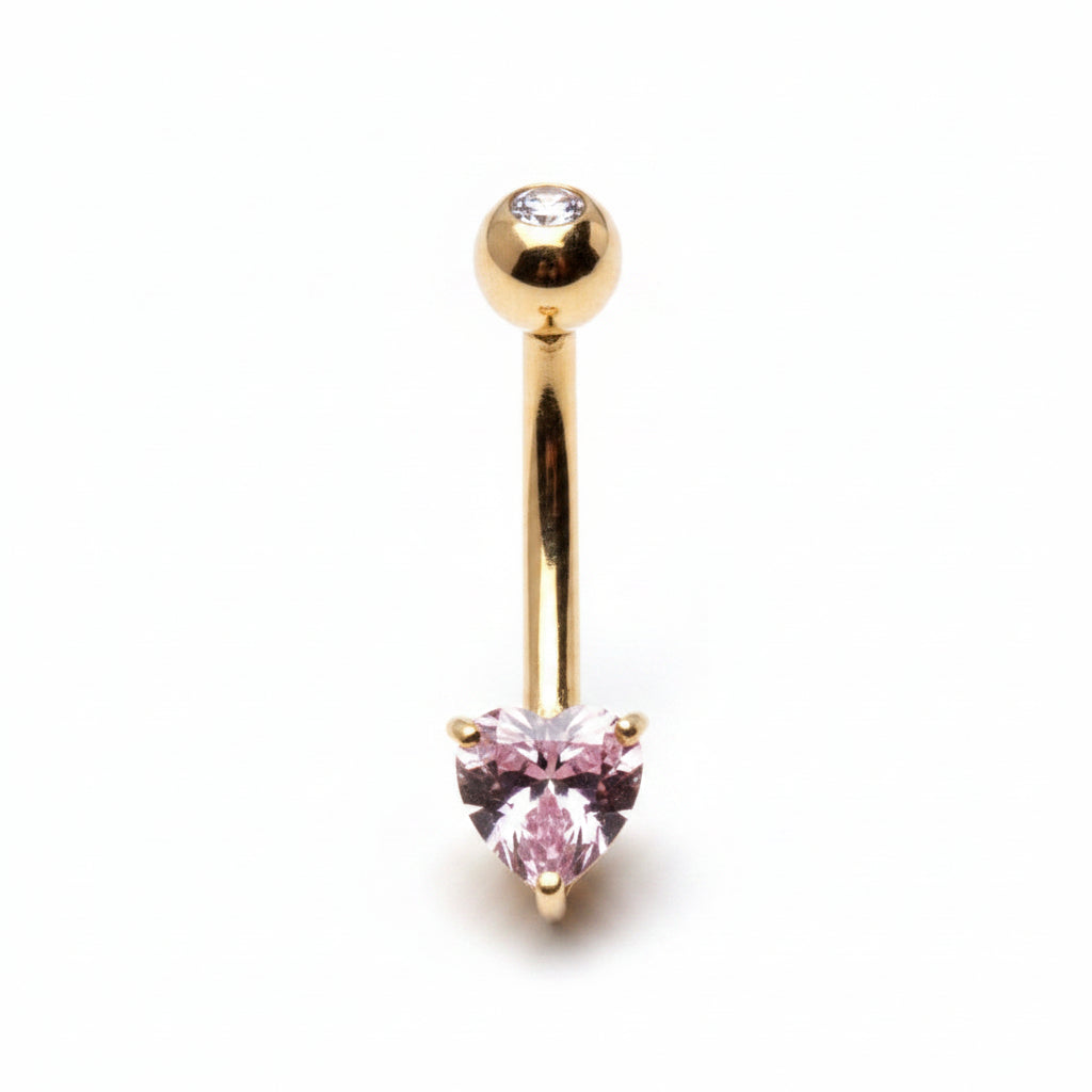 Gold belly button ring with a pink gemstone on a white background
