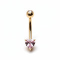 Gold belly button ring with a pink gemstone on a white background
